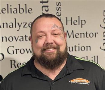 SERVPRO employee in front of motivational background