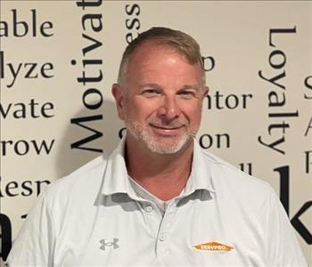 employee in front of motivational wall