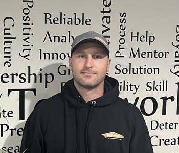 Servpro employee in front of motivational wall