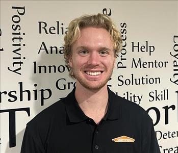 an employee in front of motivational wall