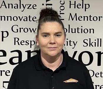 employee in front of motivational wall