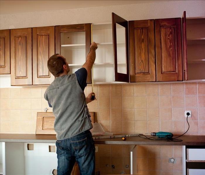 Carpenter working on new kitchen cabinets